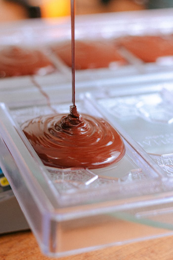 Close-up shot of artisanal chocolate being poured into a mold, Chiapas, México.